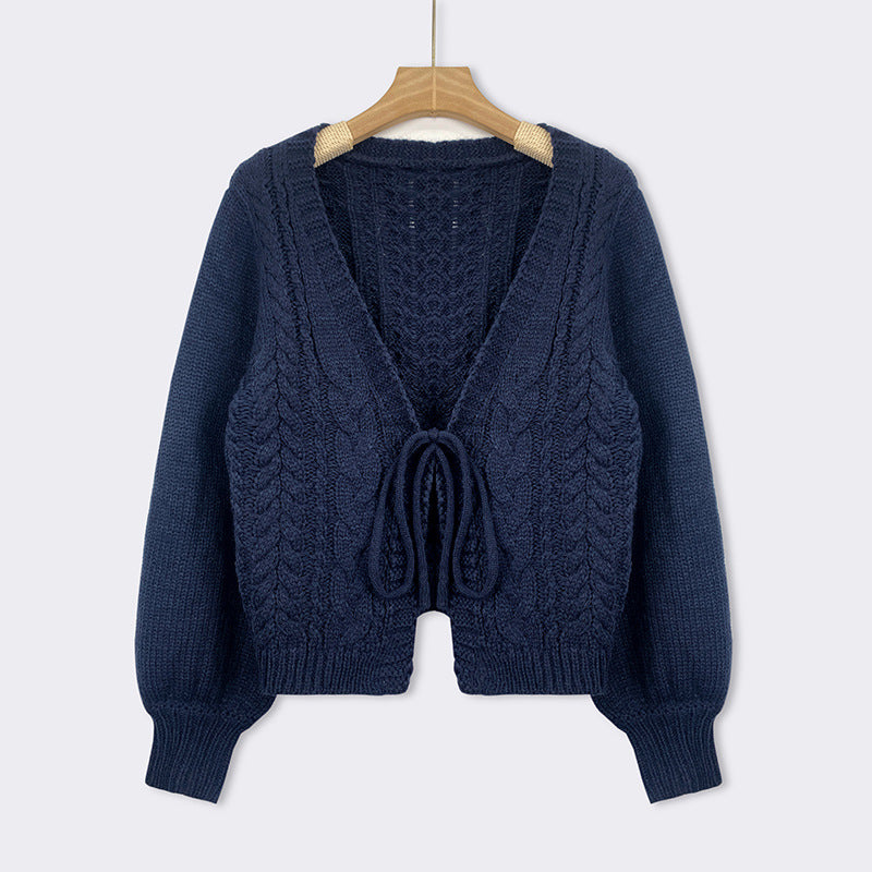 Blue cable-knit tie-front chunky cardigan with V-neck, long sleeves, and drawstring