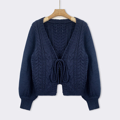Blue cable-knit tie-front chunky cardigan with V-neck, long sleeves, and drawstring