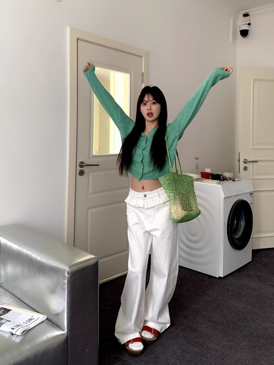 White wide-leg jeans with lace-trimmed ruffled waist and relaxed straight-leg fit