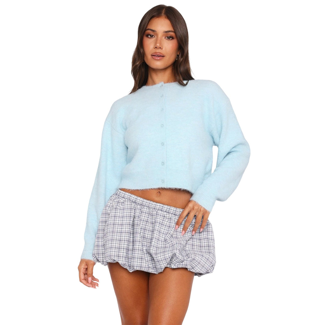 Light blue cropped cardigan with long sleeves and front button placket