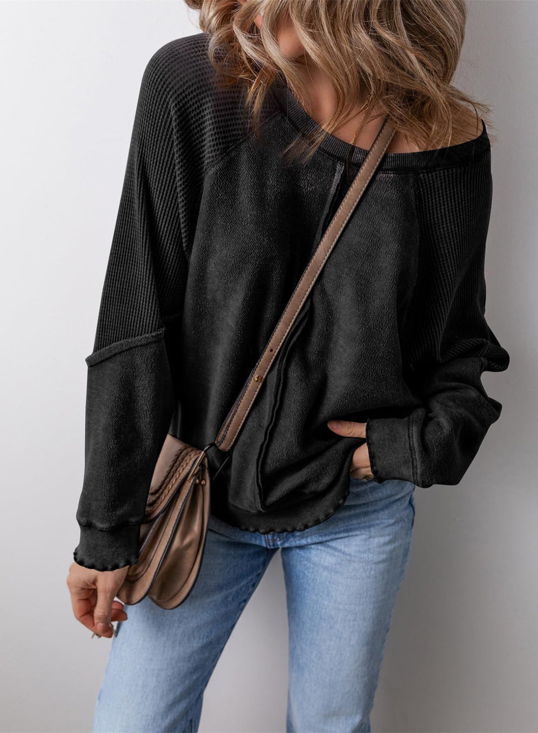 Black crew neck long-sleeve sweatshirt with ribbed cuffs and hem