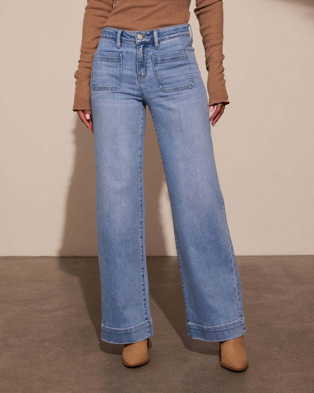 Light blue high-waist slim-fit jeans with button fly and front pockets