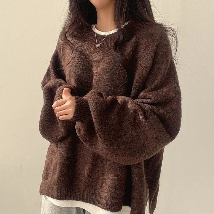 Brown oversized knit sweater with crew neck, long sleeves, ribbed cuffs and hem.