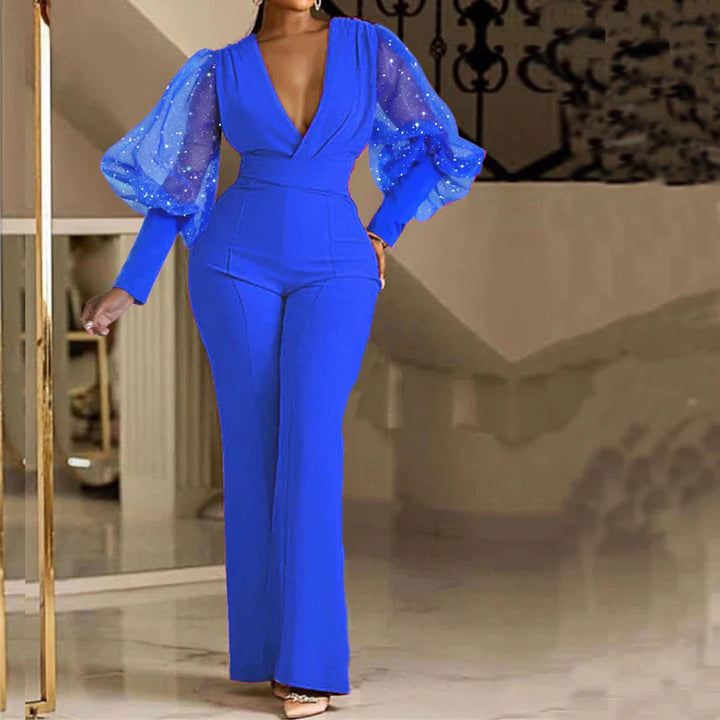 Blue embellished wrap-front jumpsuit with sheer puff sleeves and long flare legs
