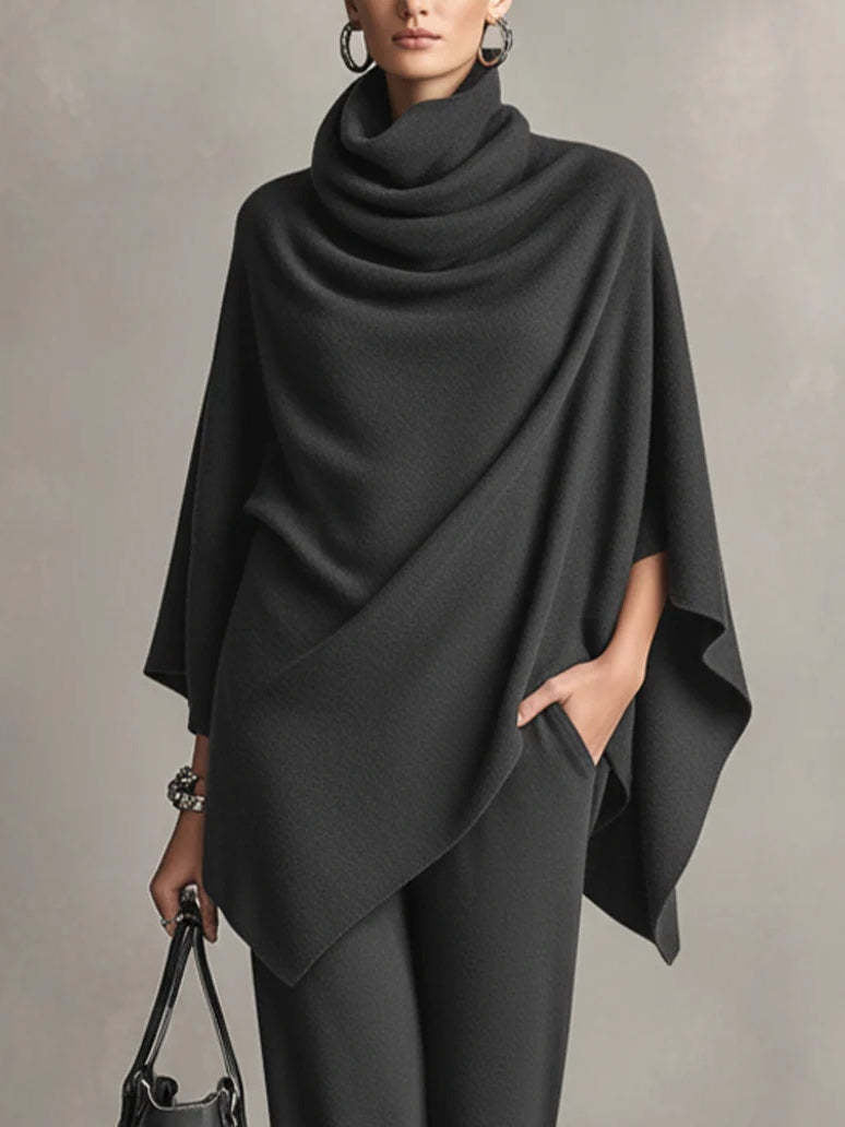 Black wide-leg trousers with draped cowl-neck cape top and asymmetrical hem