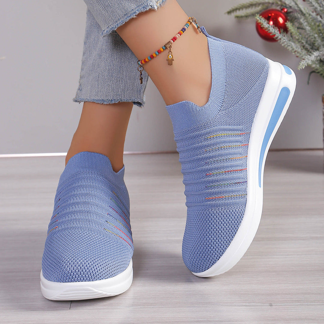 Blue knit slip-on sneakers with multicolor stripe detail and white platform sole