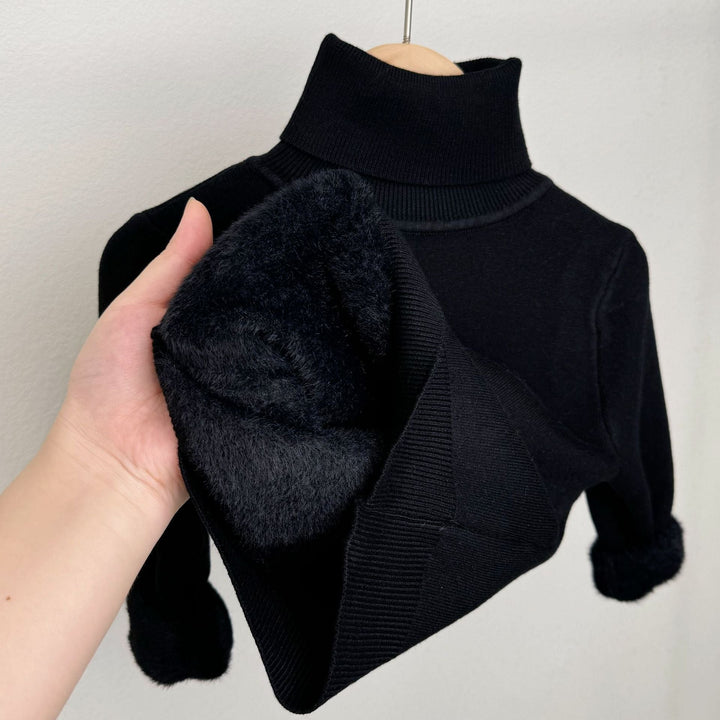 Black fleece-lined knit sweater with ribbed turtleneck; plush lining visible at cuff
