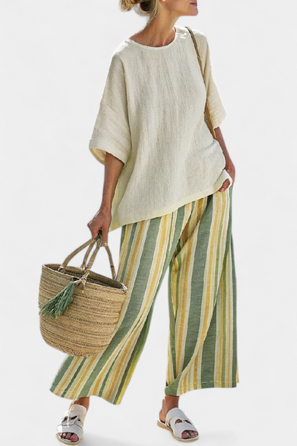 Beige linen top and green-and-yellow striped wide-leg trousers, side view