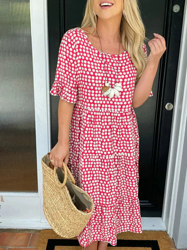 Red dot-print summer dress with flower applique, short sleeves, tiered hem