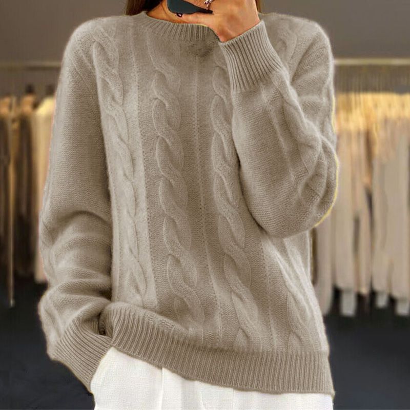 Ivory cable-knit winter sweater with crew neck, ribbed cuffs, and hem