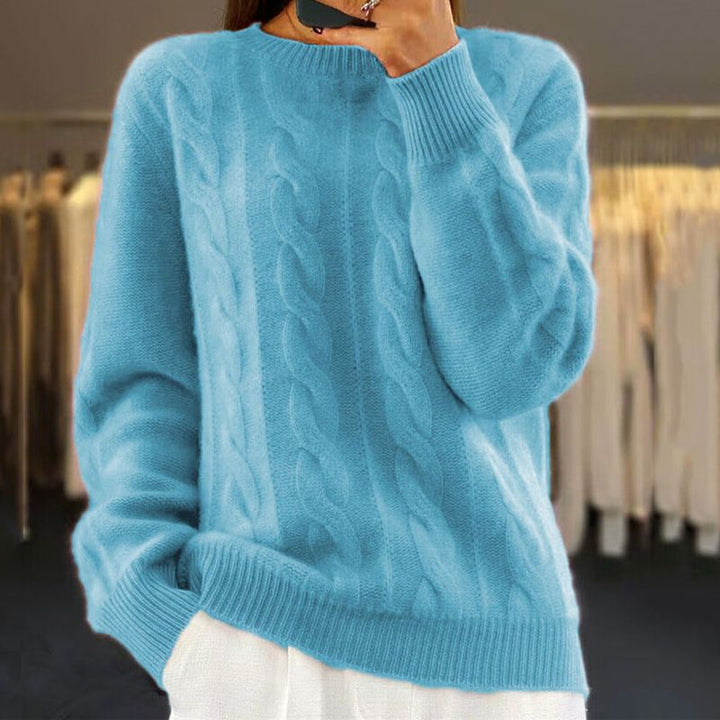 Light blue cable-knit winter sweater with crew neck, ribbed cuffs, and hem