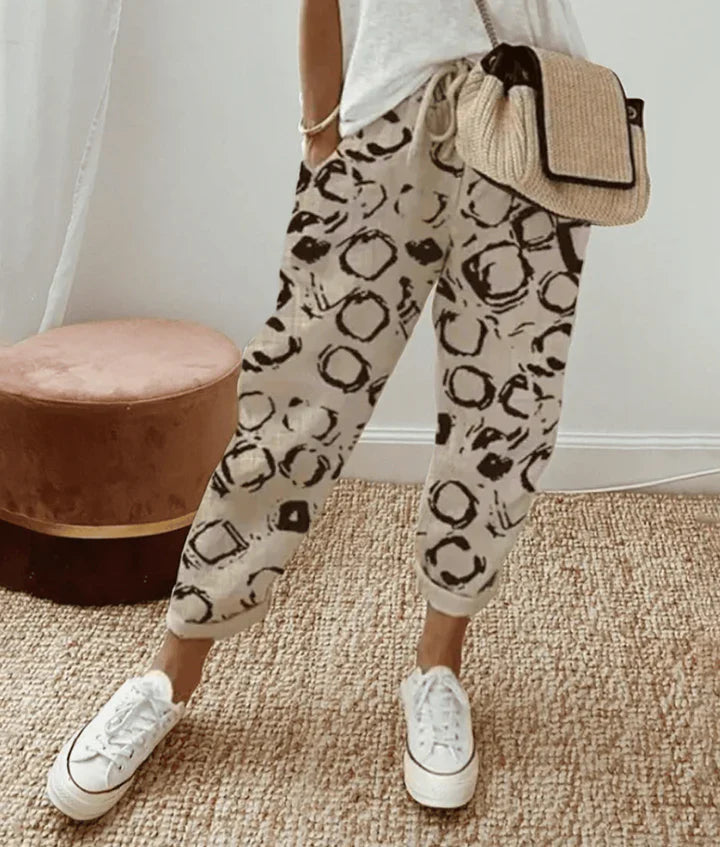 Printed retro comfort pants, light base with black abstract shapes, tapered leg cuffs
