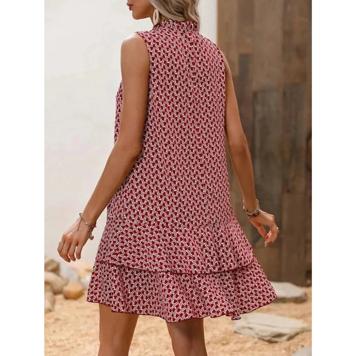 Red patterned sleeveless summer dress, back view with high neckline and tiered hem
