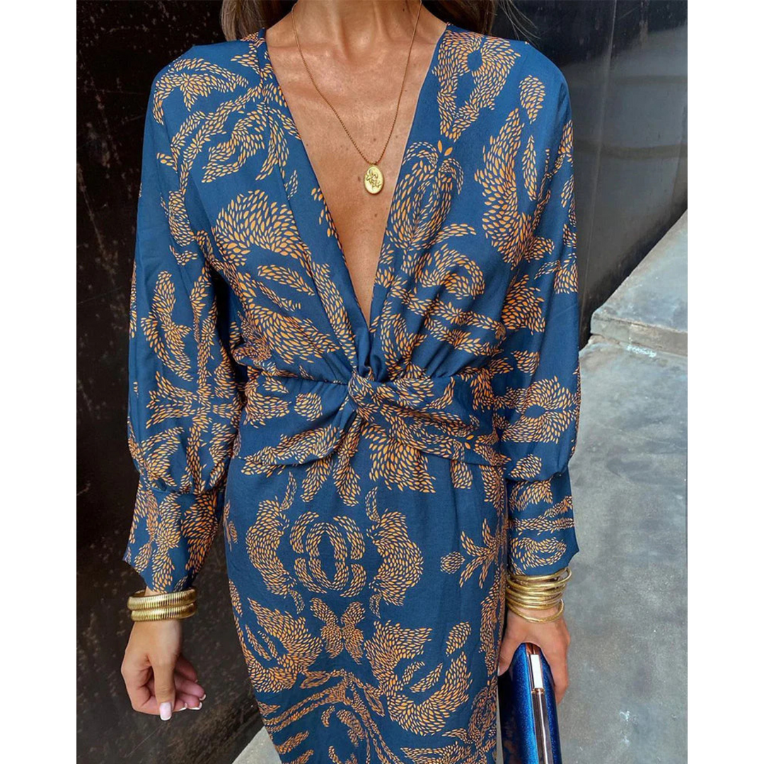 Boho elegance dress close-up: blue fabric with gold botanical print, knotted waist