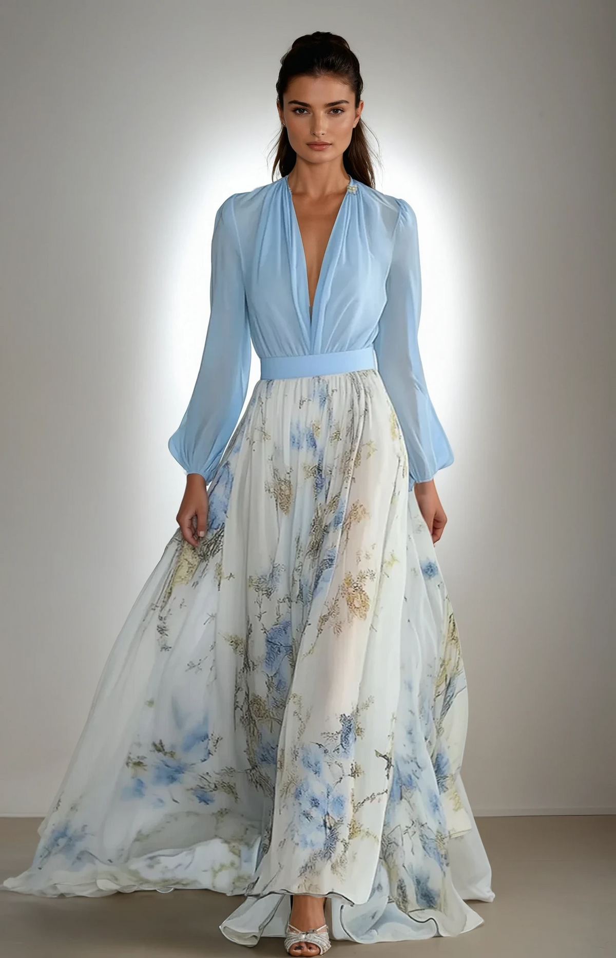 Floral maxi dress with gathered waist, light blue long sleeves, and flowing skirt