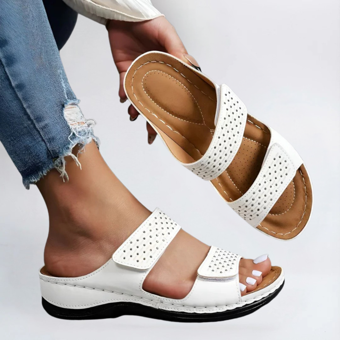 White orthopedic sandals with perforated double straps and hook-and-loop closure