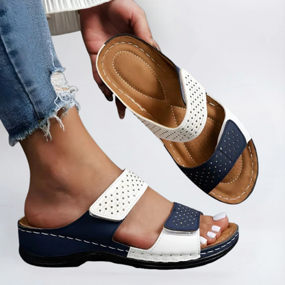 Orthopedic sandals in white and navy with perforated straps and hook-and-loop closure