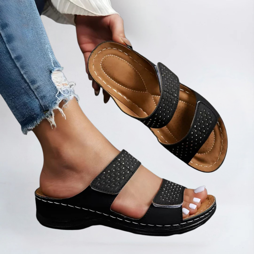 Black orthopedic sandals with perforated double straps and adjustable hook-and-loop closure