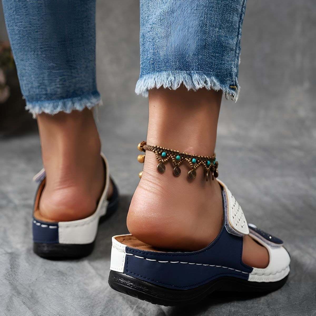 White and navy orthopedic sandals with adjustable straps and cushioned rubber sole