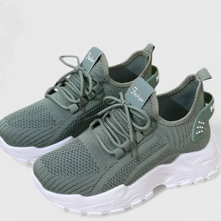 Green orthopedic sneakers with lace-up knit upper and white cushioned soles.