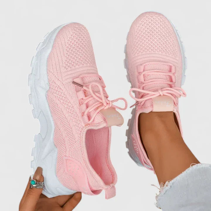 Light pink orthopedic sneakers with lace-up knit upper and padded chunky sole.