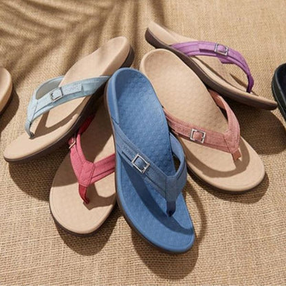Orthopedic sandals in mixed colors: light blue, pink, cream, and purple, with toe thongs.