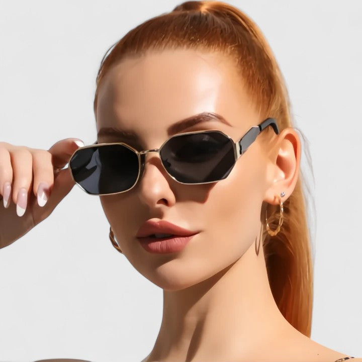 Jaylynne sunglasses on model with dark lenses and gold-tone angular frame