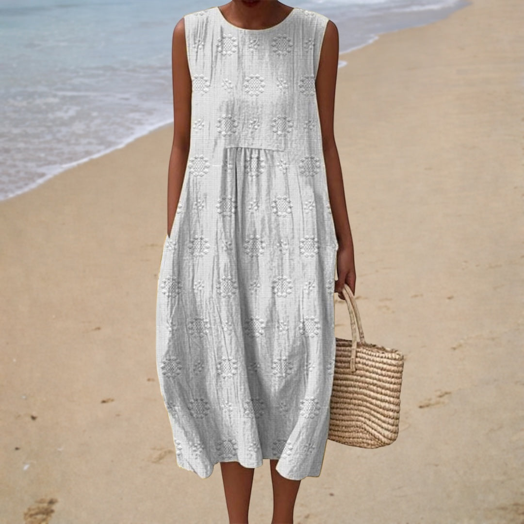 White sleeveless summer dress with embroidered bodice and gathered tiered skirt