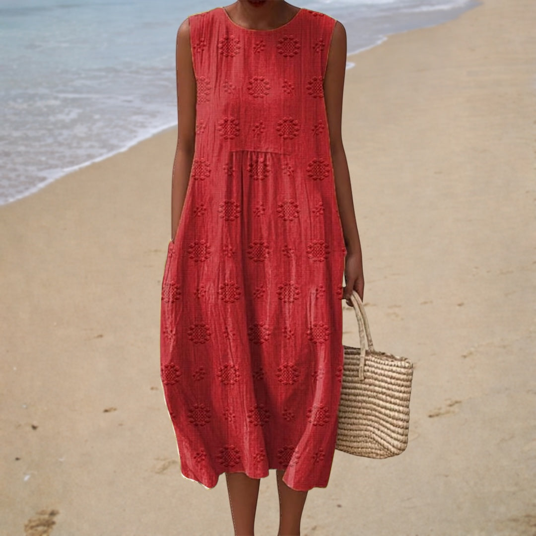 Red sleeveless summer dress with round neck and textured floral pattern, midi length