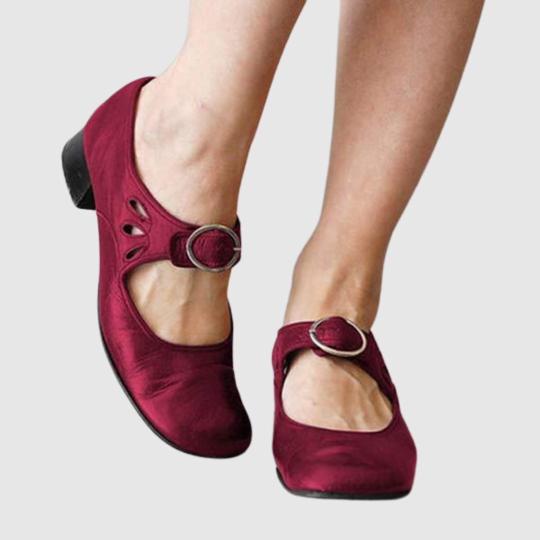 Burgundy leather Mary Jane flats with oval cutout strap and round metal buckle
