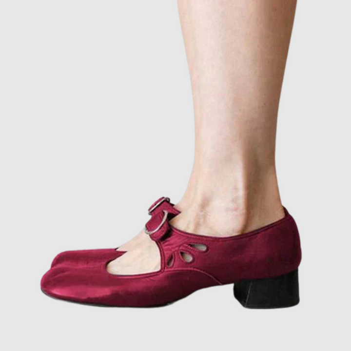 Burgundy leather Mary Jane flats side view with oval cutout strap and metal buckle