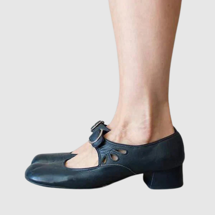 Blue leather Mary Jane flats side view with oval cutout strap and metal buckle