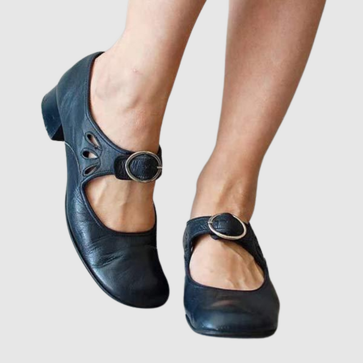 Blue leather Mary Jane flats with oval cutout strap and round metal buckle