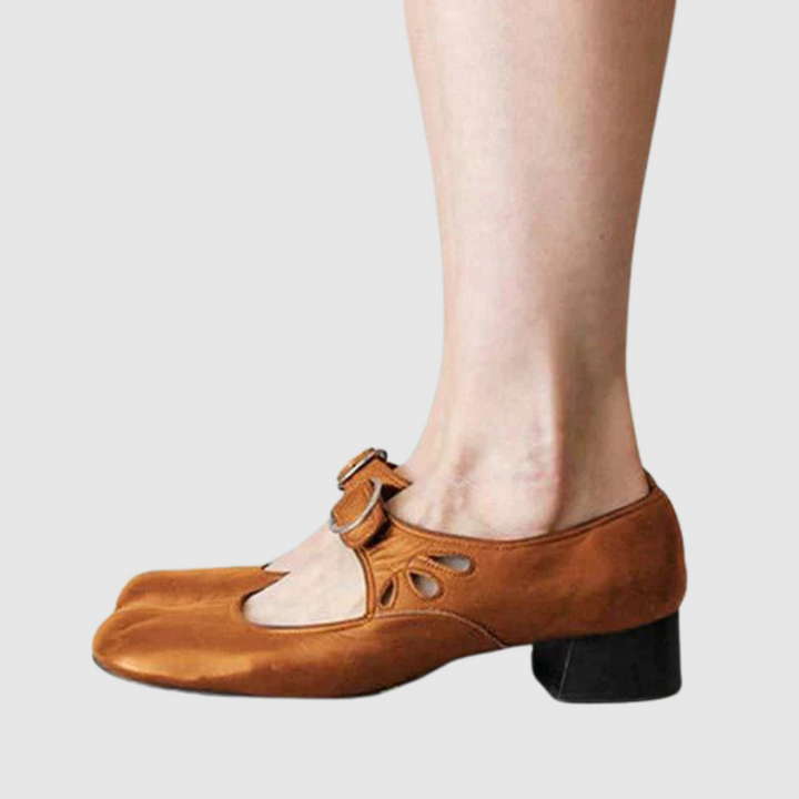 Brown leather Mary Jane flats side view with oval cutout strap and metal buckle