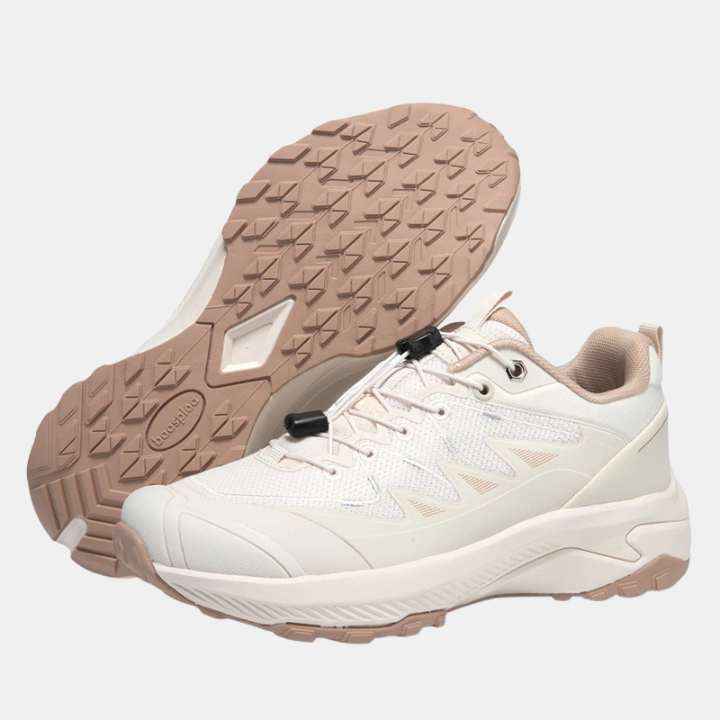 White sneakers outsole with rugged tread and elastic buckle detail on upper