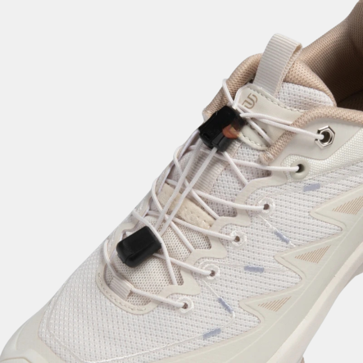 White mesh sneaker upper with lace-up front and black elastic buckle strap
