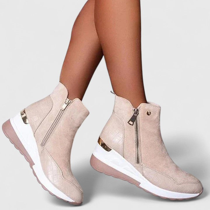 Beige orthopedic ankle boots with side zipper and white cushioned sole.
