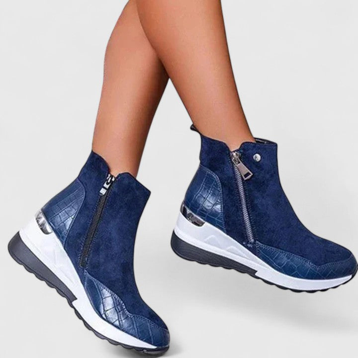 Blue orthopedic ankle boots with side zipper, stitched design, and white sole.