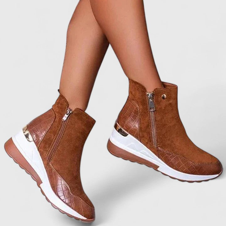 Brown orthopedic ankle boots with side zipper and thick white cushioned sole.