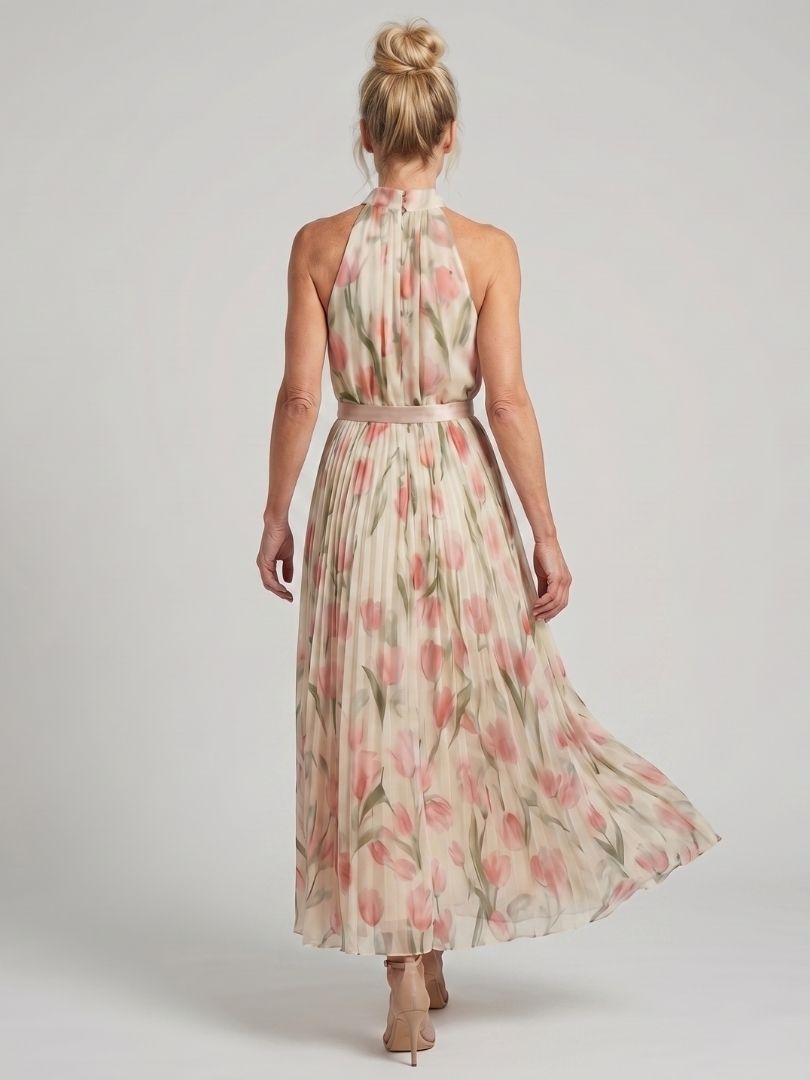 Halter neck floral midi dress from behind with tie belt and tulip print pleats