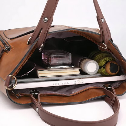 Brown PU leather crossbody tote open top with inner compartments and visible zipper pockets.