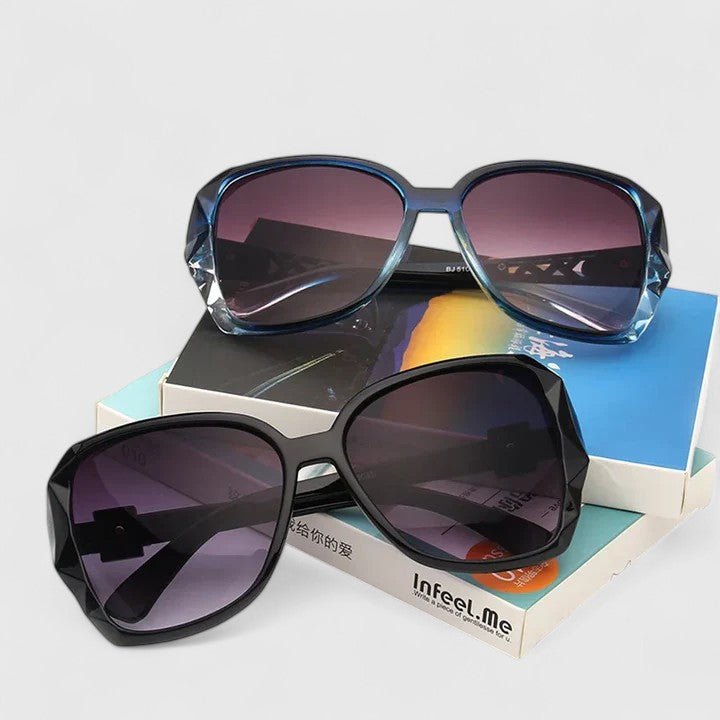 Sunglasses with dark lenses in black frames and blue frames, plus a third purple-lens pair