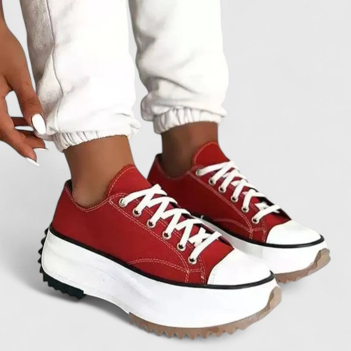 Red platform sneakers with white rubber sole and lace-up front