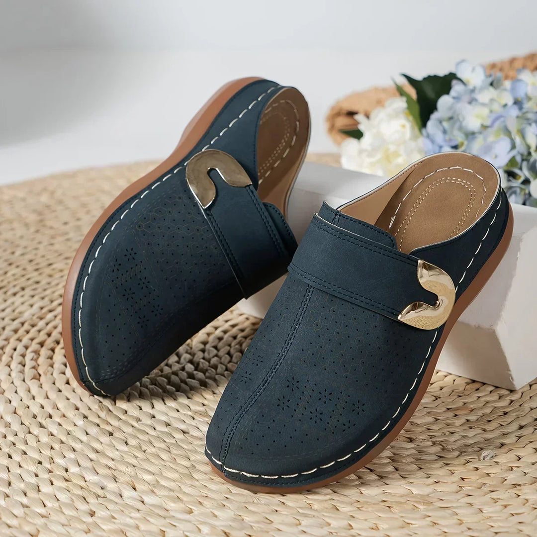 Navy blue perforated wedge sandals with adjustable strap and gold-tone buckle