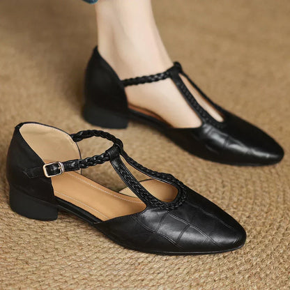 Black leather Mary Jane flats with ankle strap buckle and T-strap cutout front
