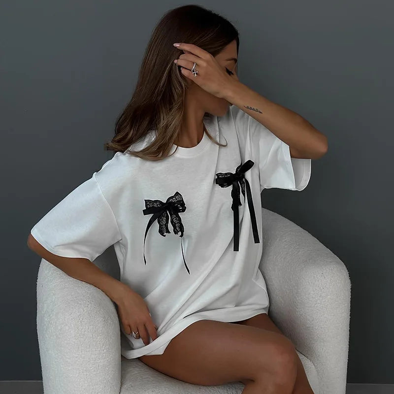 Women’s white bow tee with black lace bows, loose short sleeves and curved hem