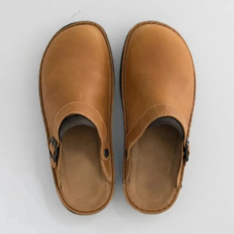 Tan leather clogs with open back and adjustable buckle strap