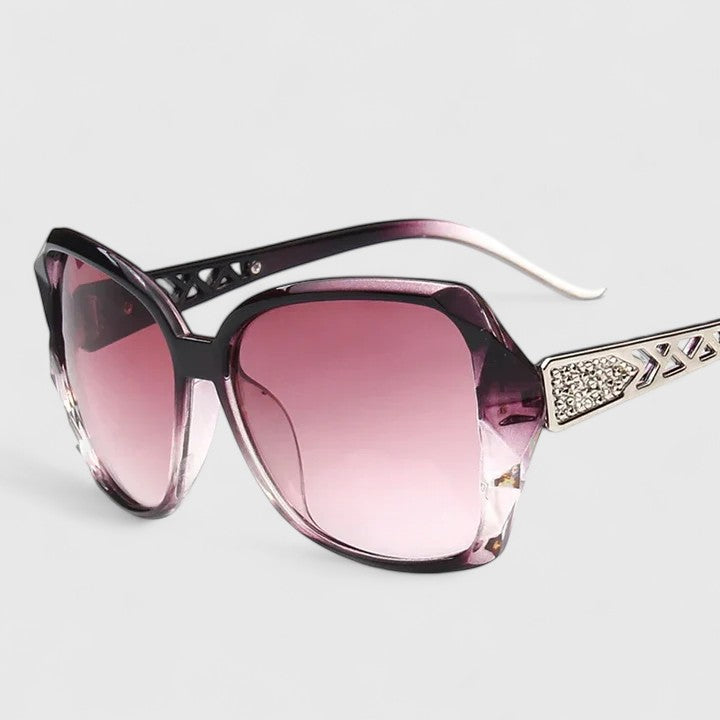 Black sunglasses with lilac-tinted lenses and rhinestone-accented temple bar