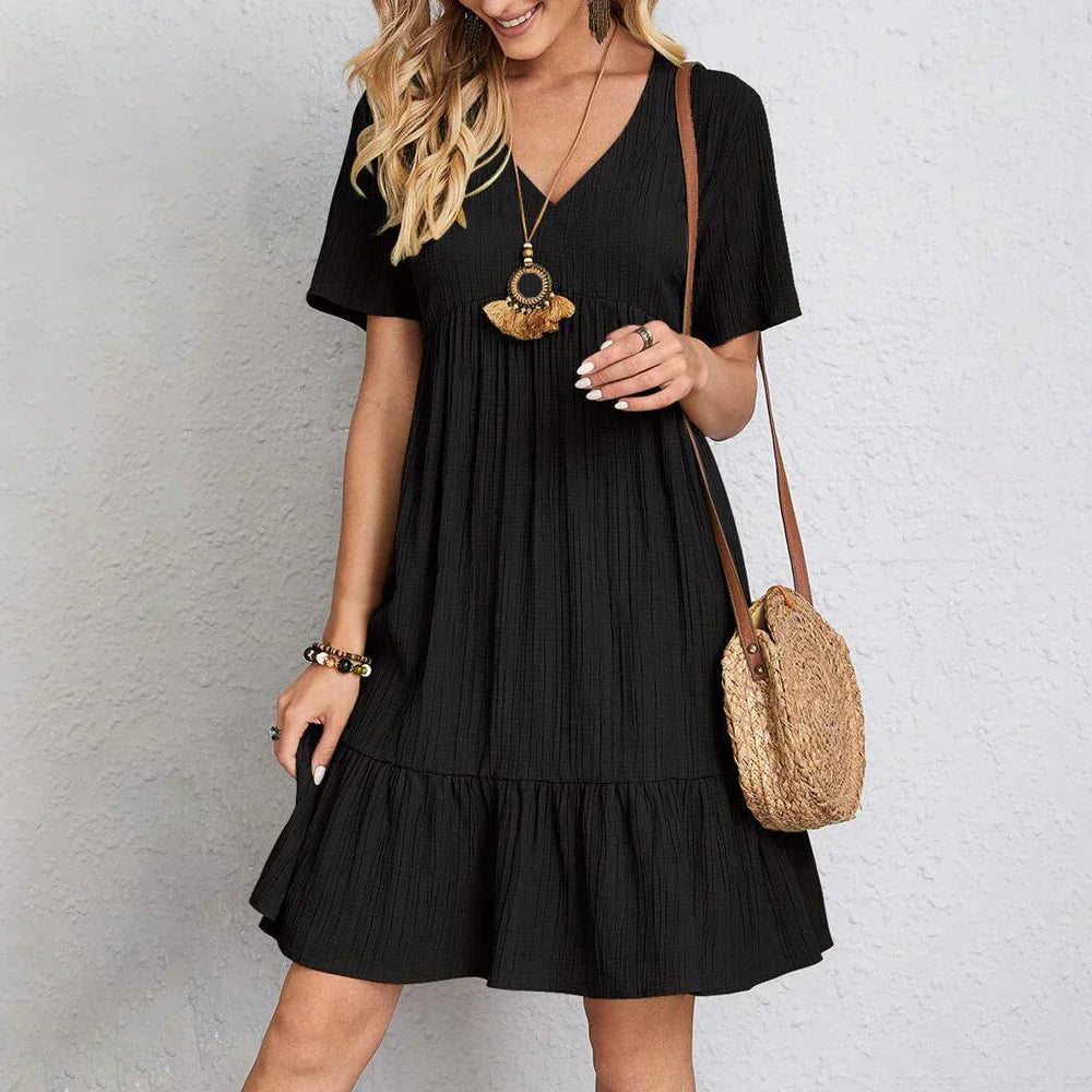 Black casual summer dress with V-neck, short sleeves, and tiered skirt