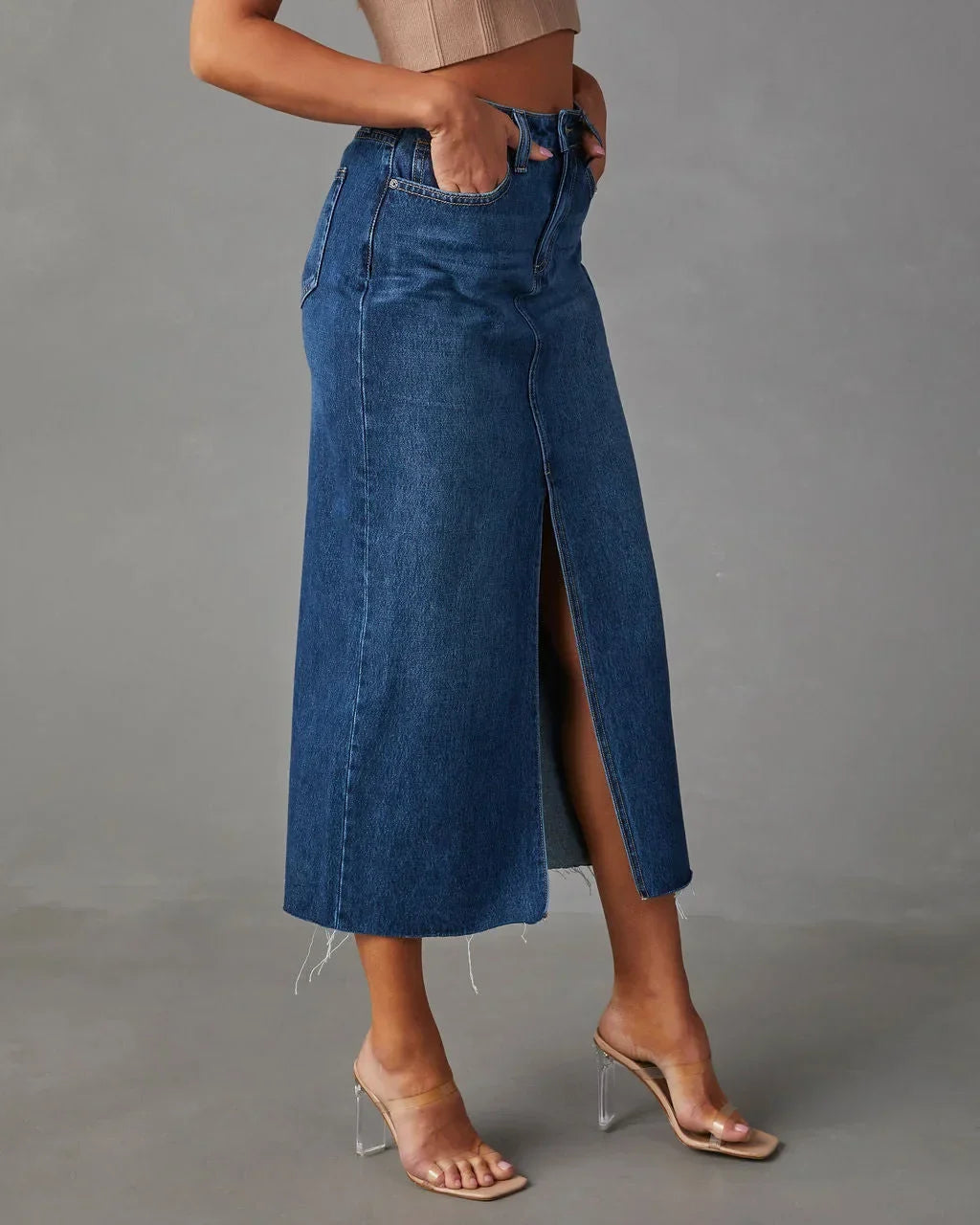Blue high-waist denim midi skirt with side slit and raw hem